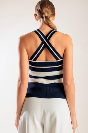 A navy and white striped sweater knit top featuring a halter neckline button down closure and cross back strap.
