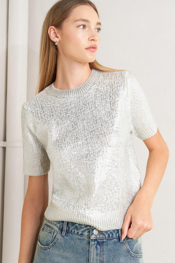 A foiled sweater knit top featuring crew neckline and short sleeve