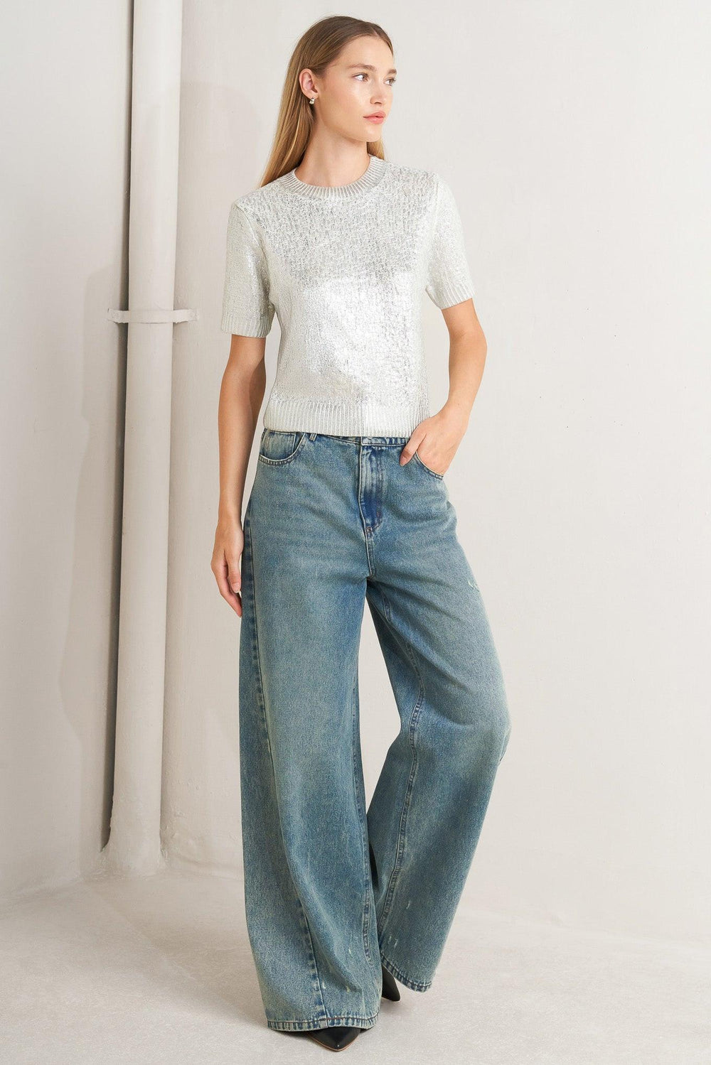 A foiled sweater knit top featuring crew neckline and short sleeve