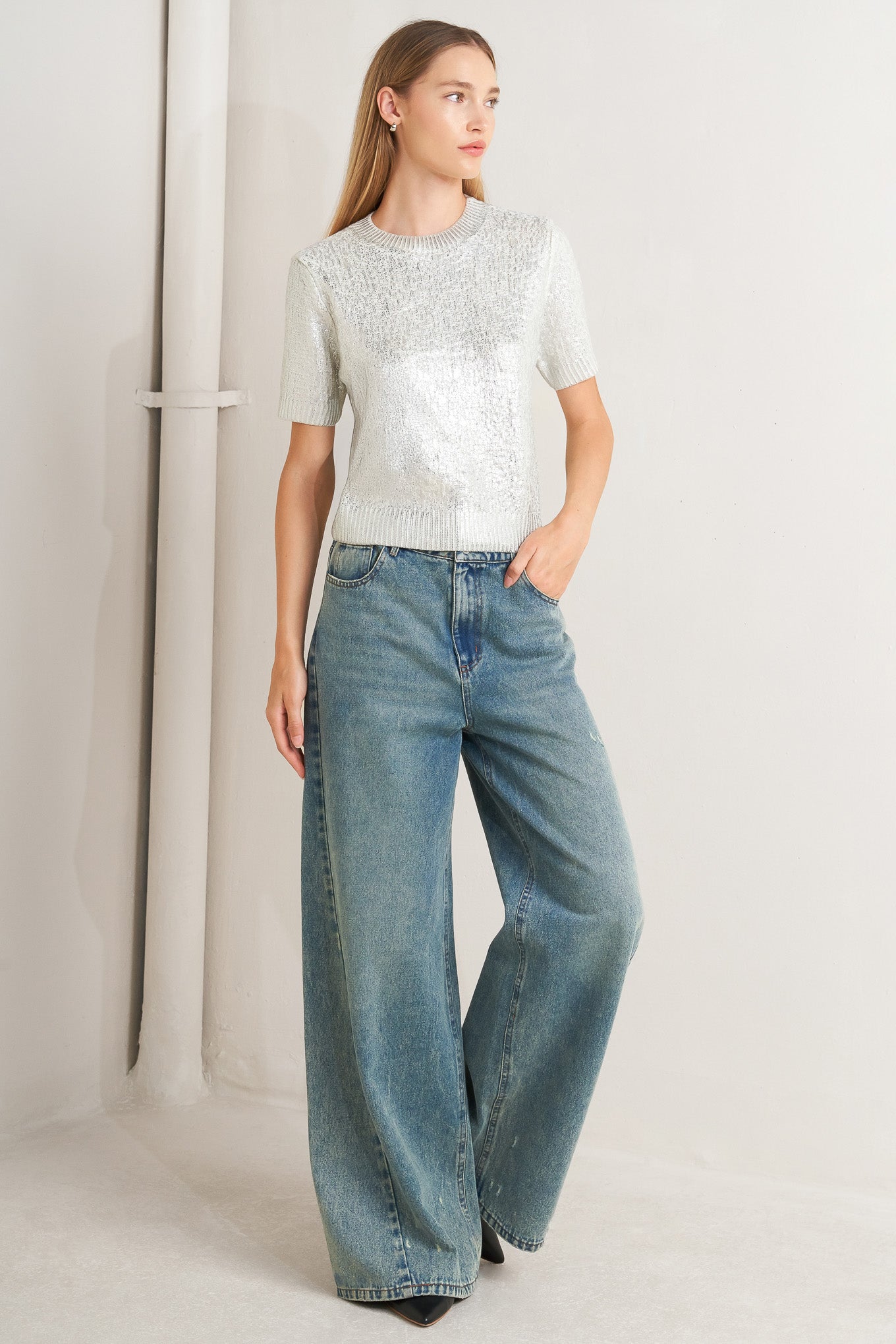 A foiled sweater knit top featuring crew neckline and short sleeve