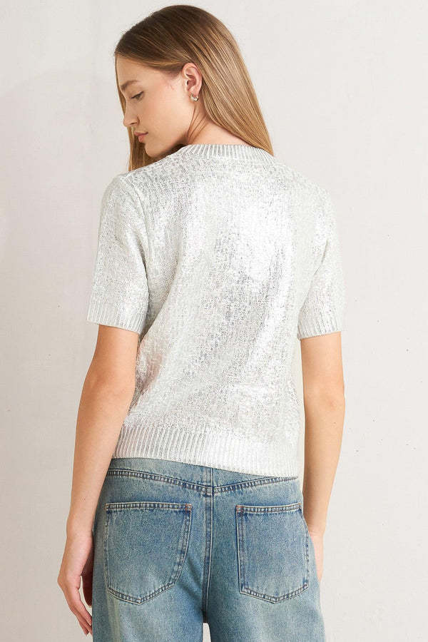 A foiled sweater knit top featuring crew neckline and short sleeve