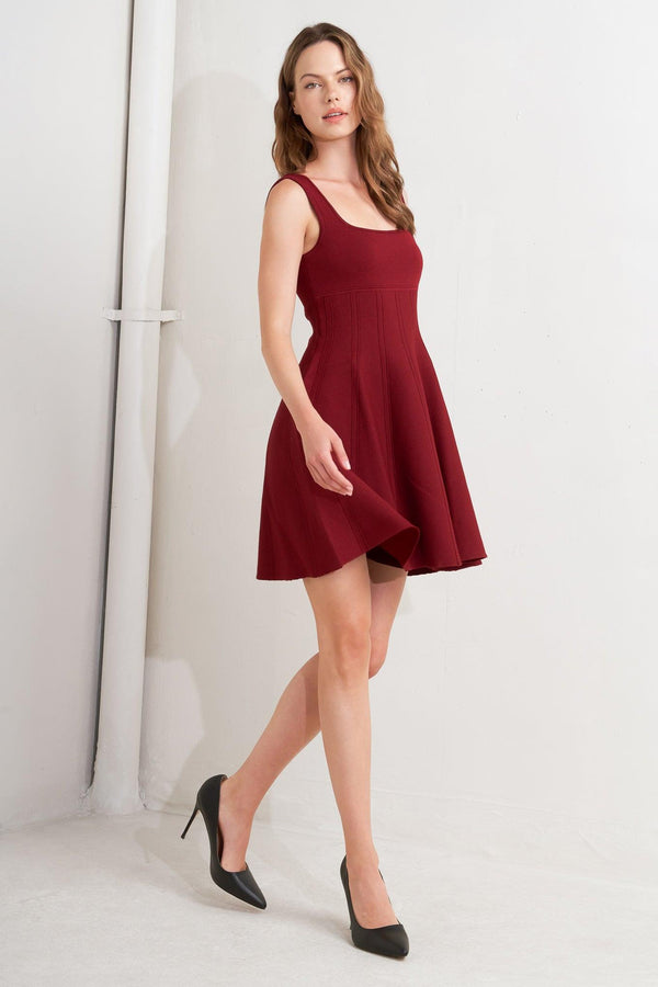 A solid sweater knit mini dress featuring square neckline, sleeveless and full skirt