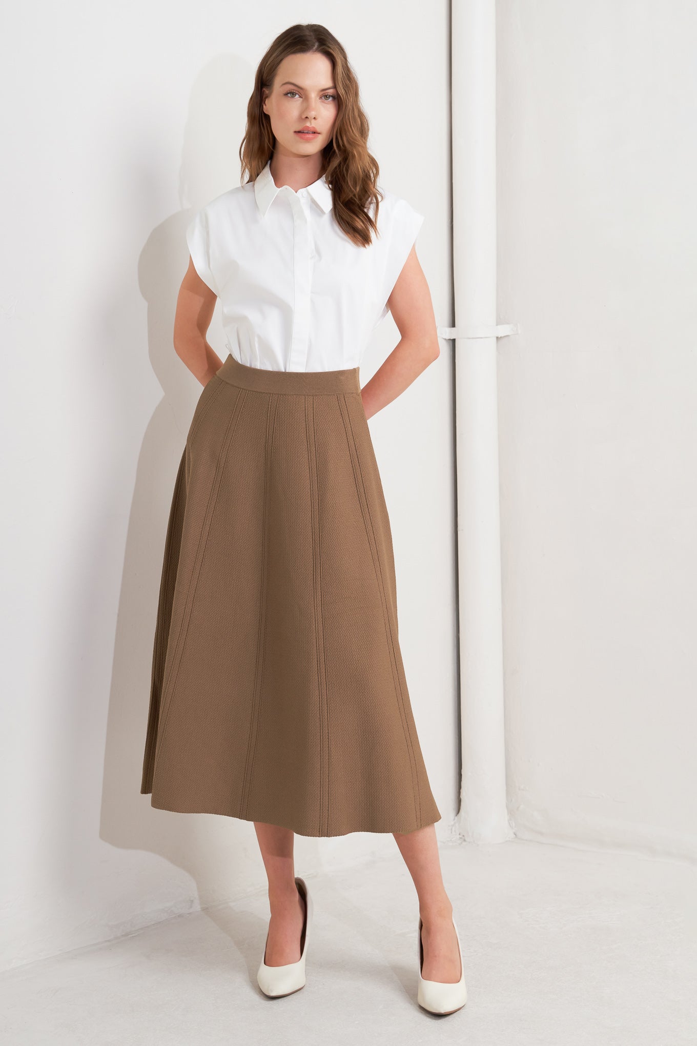 This skirt features a camel-colored sweater knit fabric crafted in a circular silhouette.