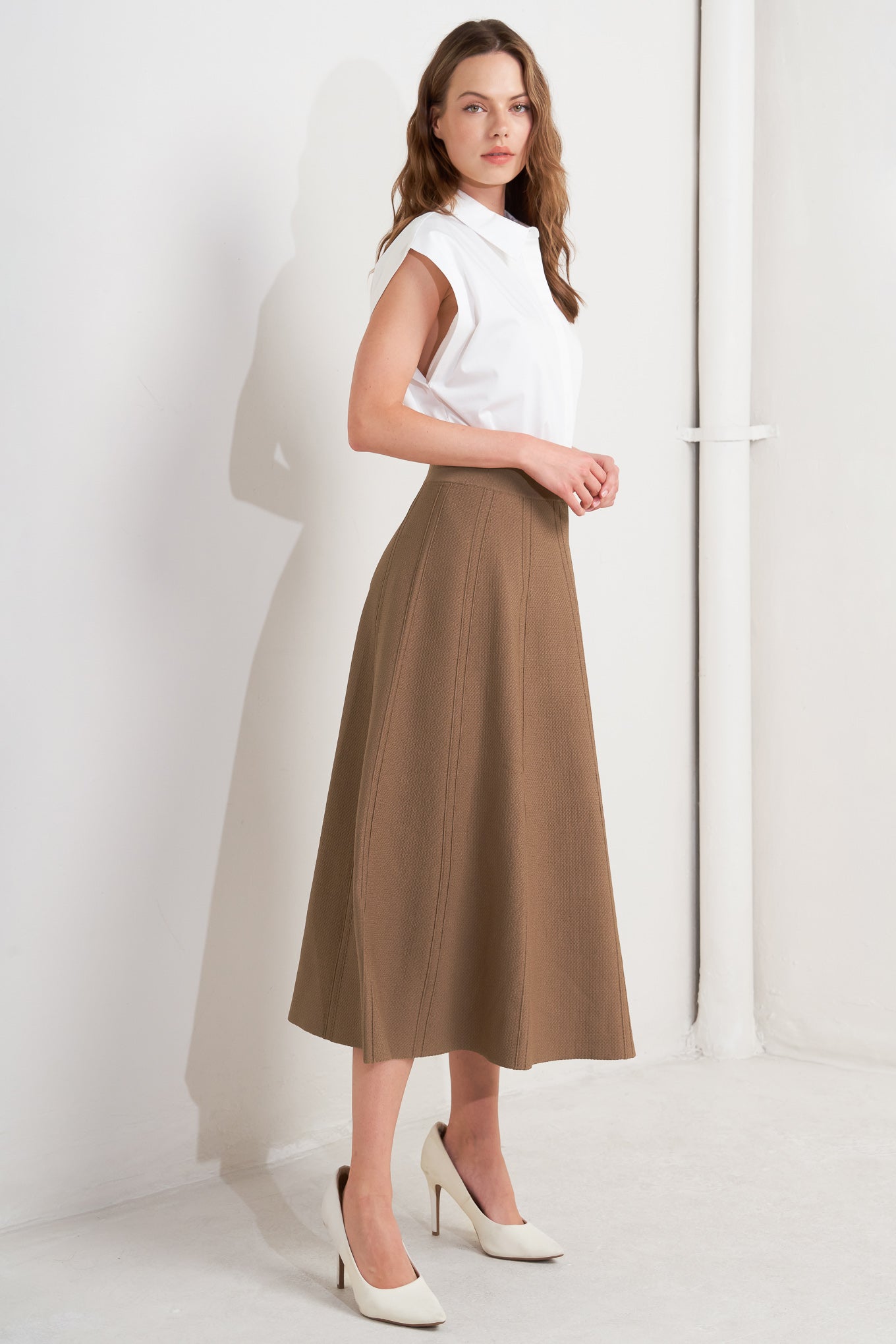 This skirt features a camel-colored sweater knit fabric crafted in a circular silhouette.