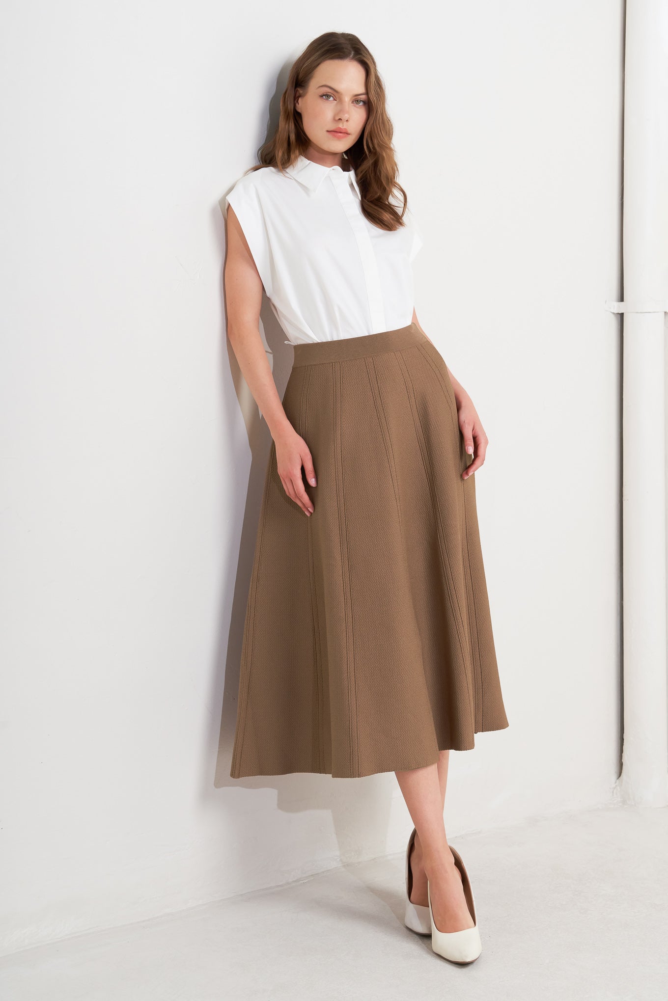 This skirt features a camel-colored sweater knit fabric crafted in a circular silhouette.
