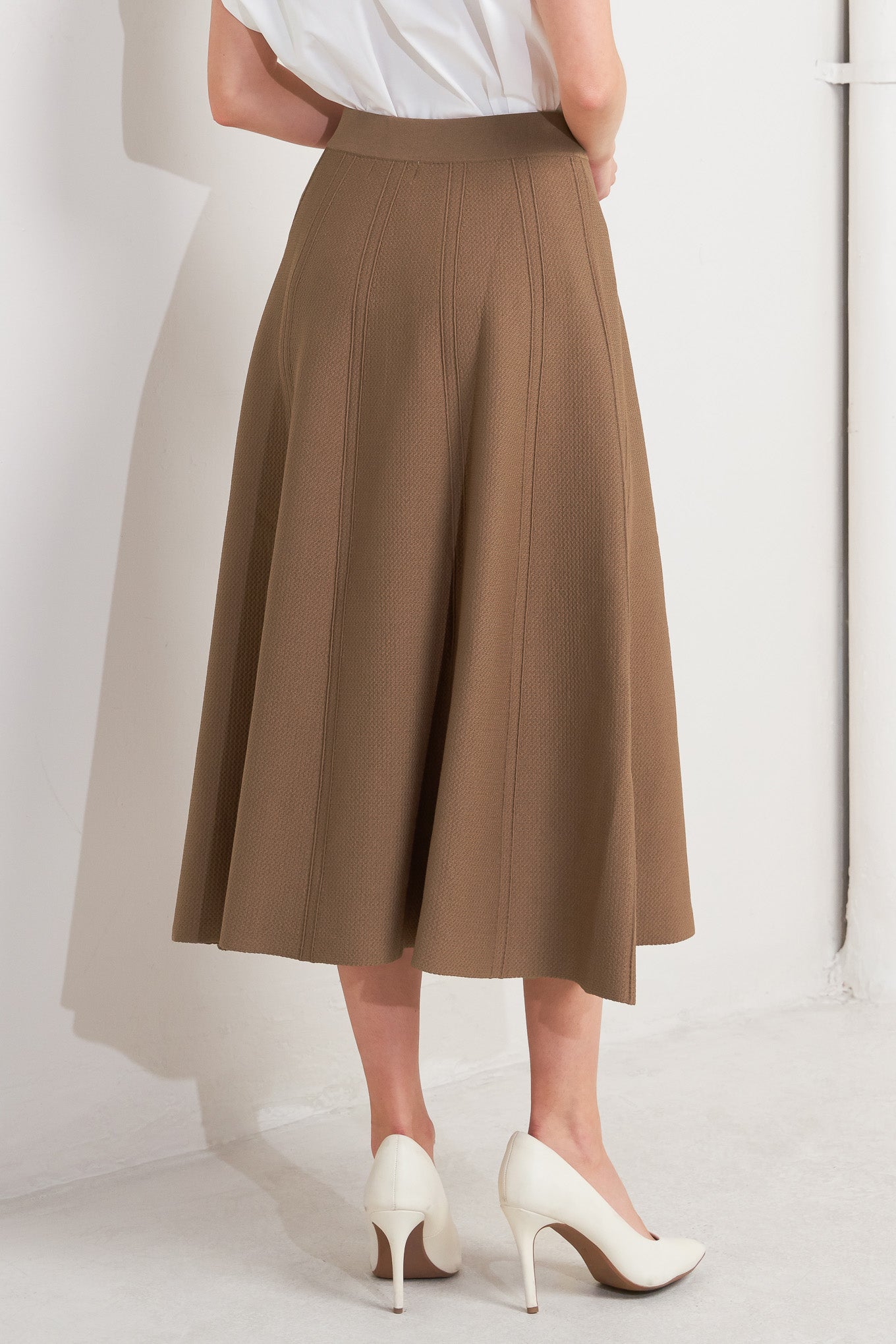 This skirt features a camel-colored sweater knit fabric crafted in a circular silhouette.