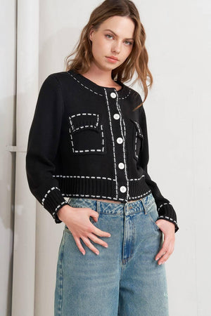 A sweater knit top featuring round neckline, button down, long sleeve and stitch edge detail