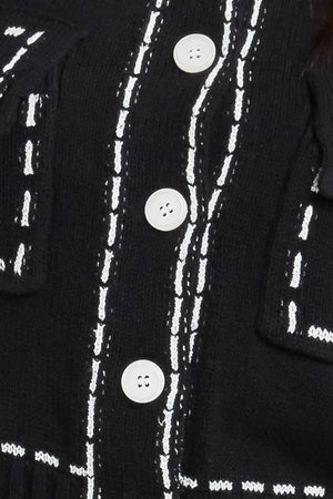 A sweater knit top featuring round neckline, button down, long sleeve and stitch edge detail