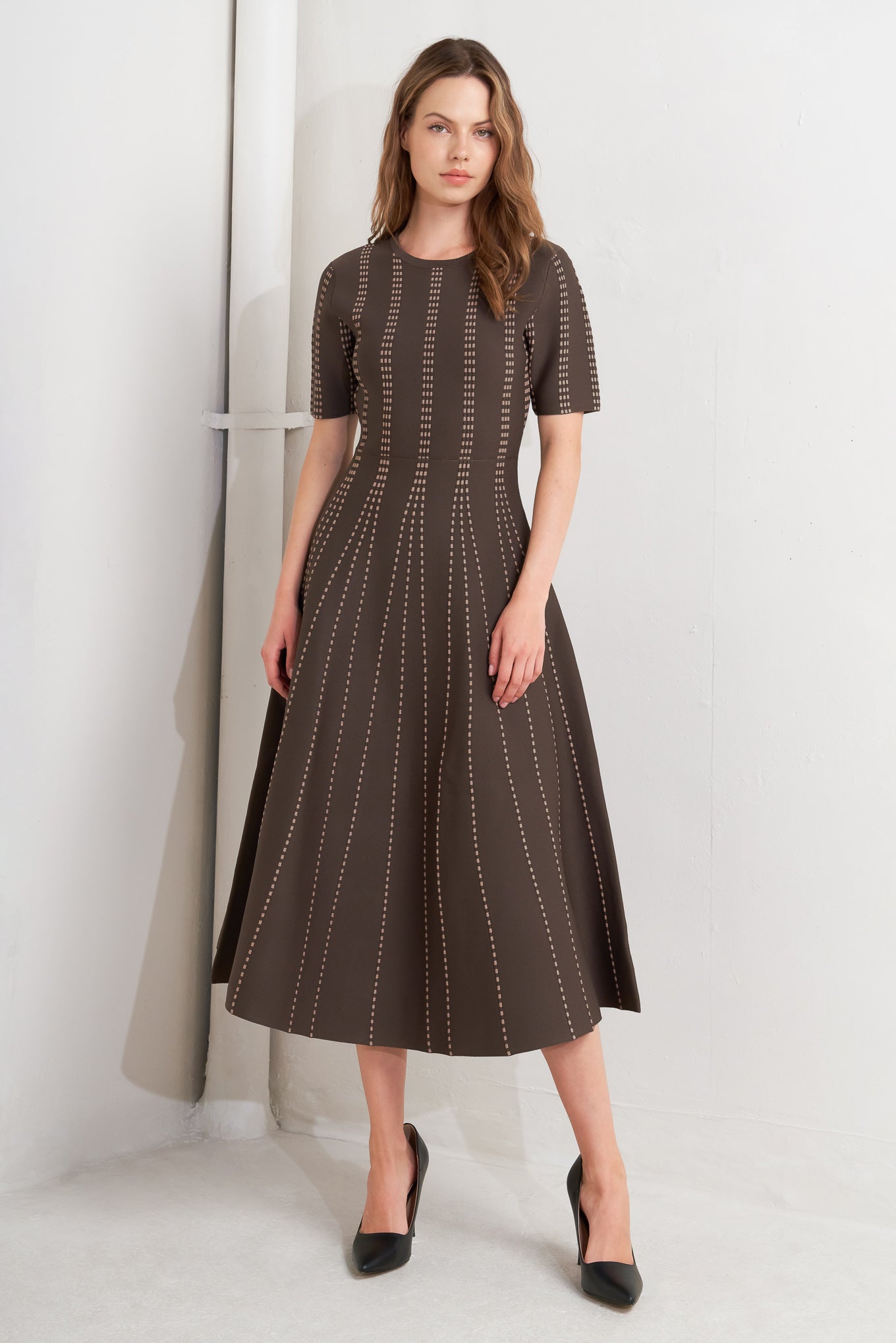 A sweater knit midi dress featuring round neckline, short sleeve and circle skirt