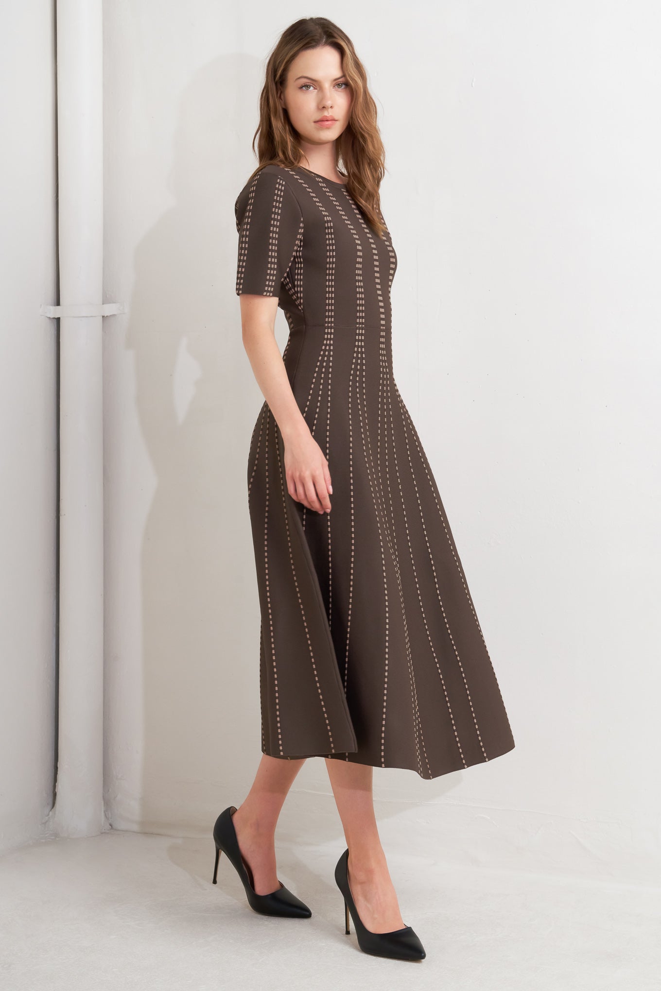 A sweater knit midi dress featuring round neckline, short sleeve and circle skirt