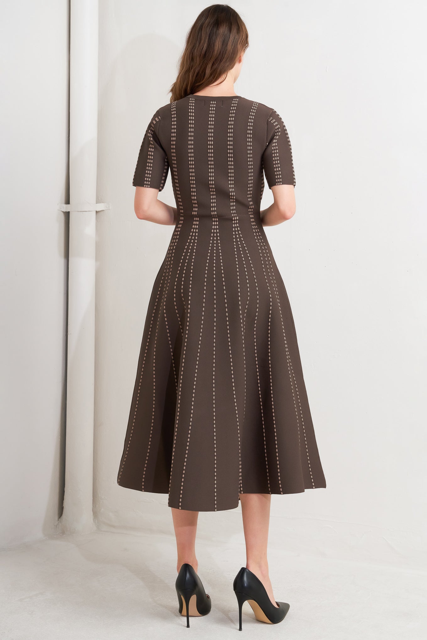 A sweater knit midi dress featuring round neckline, short sleeve and circle skirt