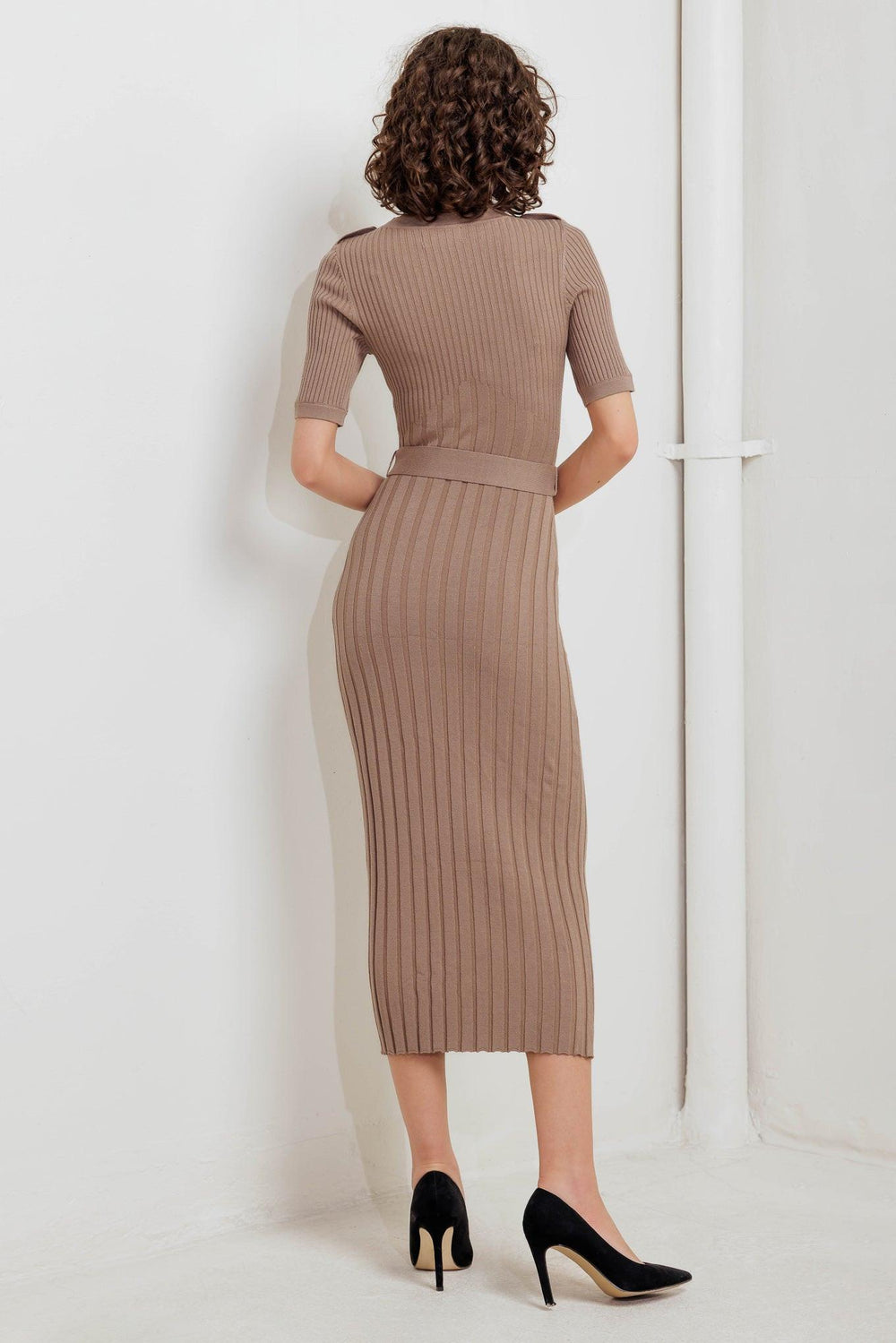 A ribbed sweater midi dress featuring round neckline, shoulder tab with button, short sleeve and self belt