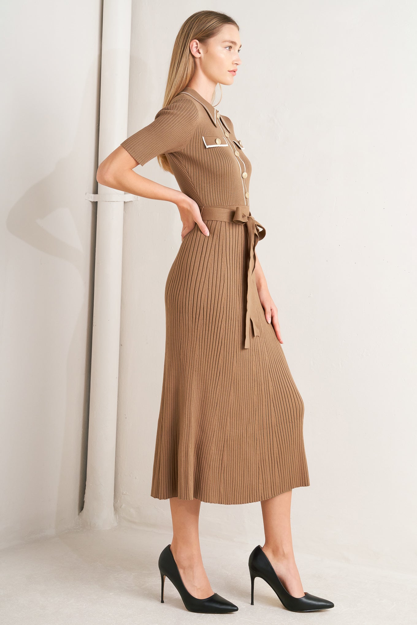A ribbed sweater knit midi dress featuring collar, front button down and self sash tie