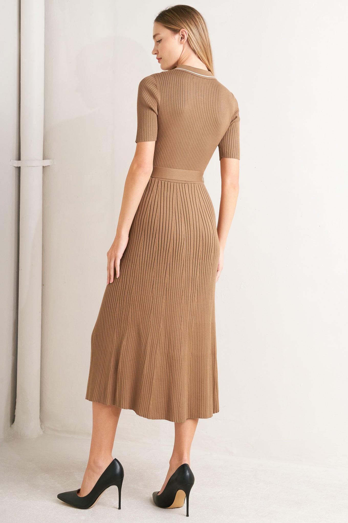A ribbed sweater knit midi dress featuring collar, front button down and self sash tie