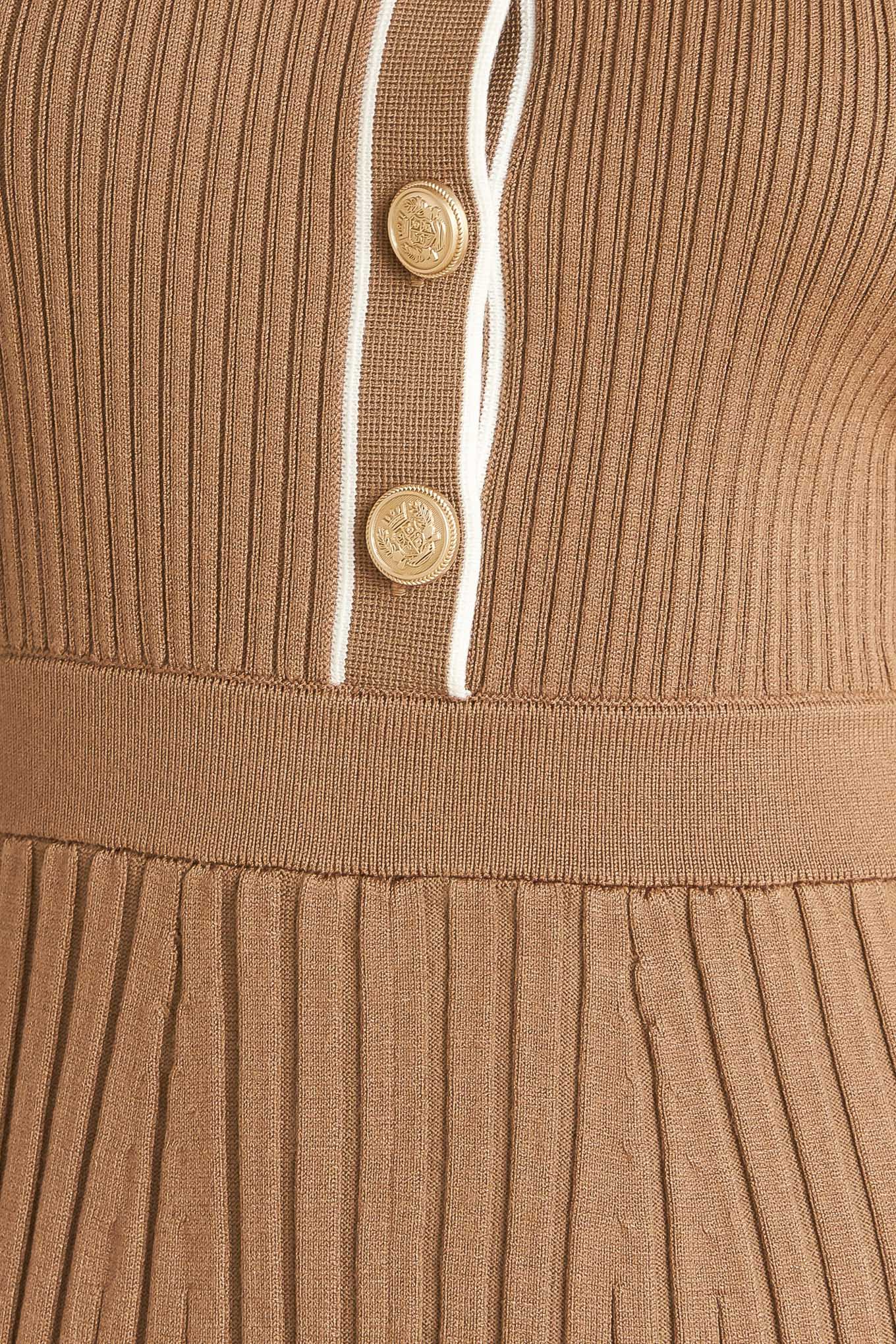 A ribbed sweater knit midi dress featuring collar, front button down and self sash tie