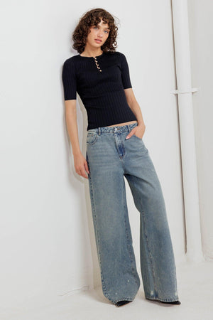 A ribbed sweater knit top featuring round neckline, front button closure and short sleeve