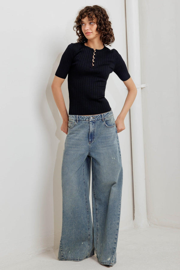 A ribbed sweater knit top featuring round neckline, front button closure and short sleeve