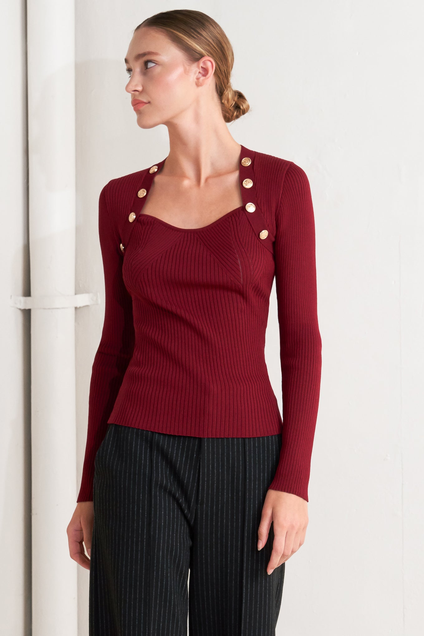 A sweater knit top with button detail