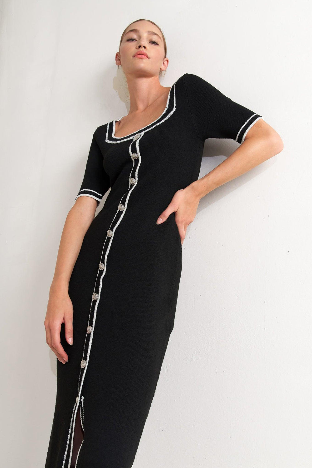 A sweater knit midi dress featuring square neckline, short sleeve and front button detail