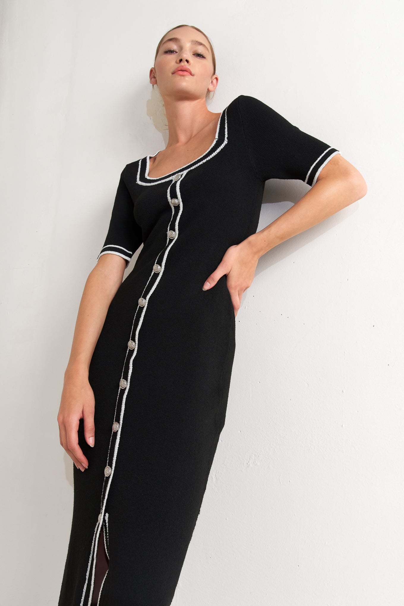 A sweater knit midi dress featuring square neckline, short sleeve and front button detail