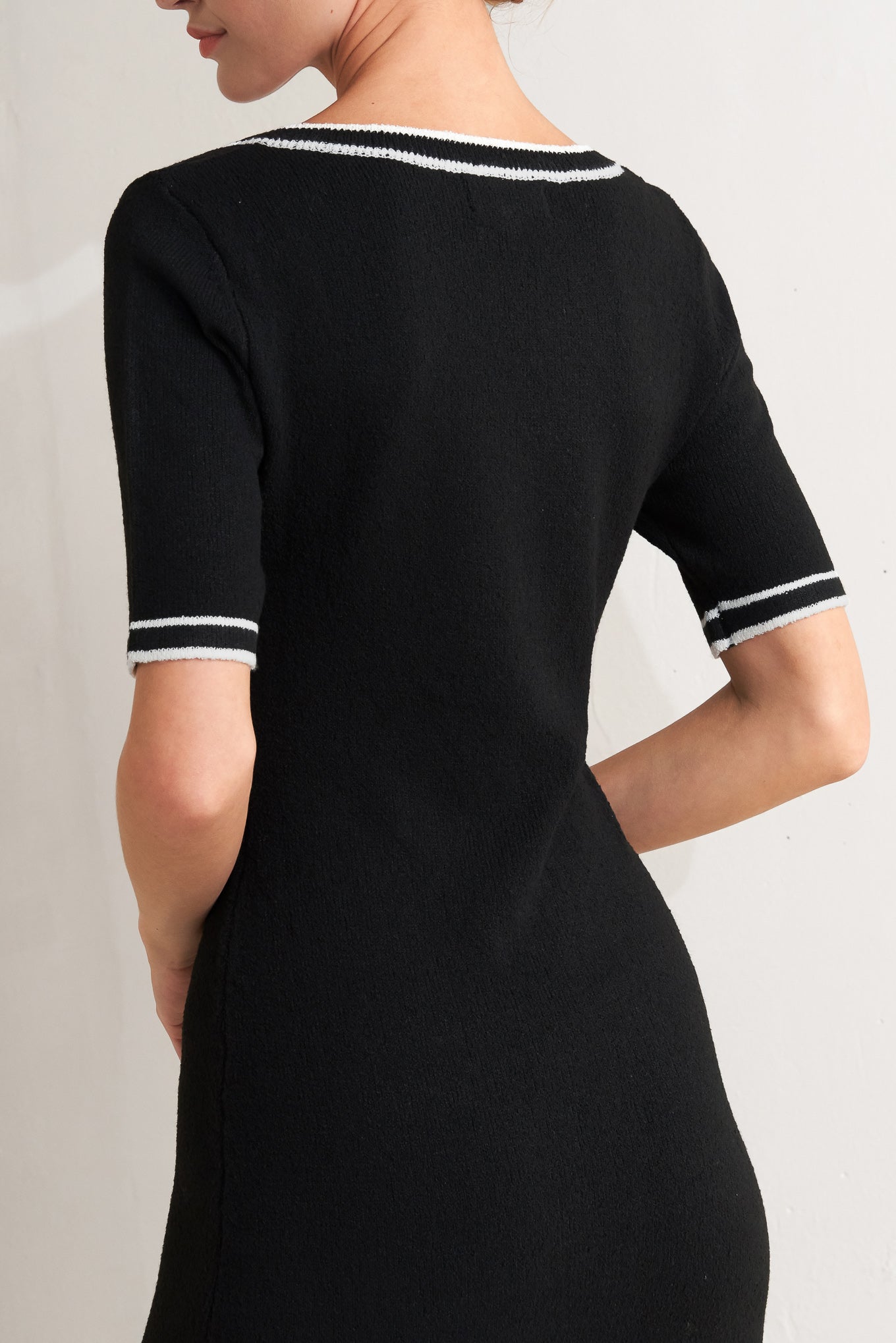 A sweater knit midi dress featuring square neckline, short sleeve and front button detail