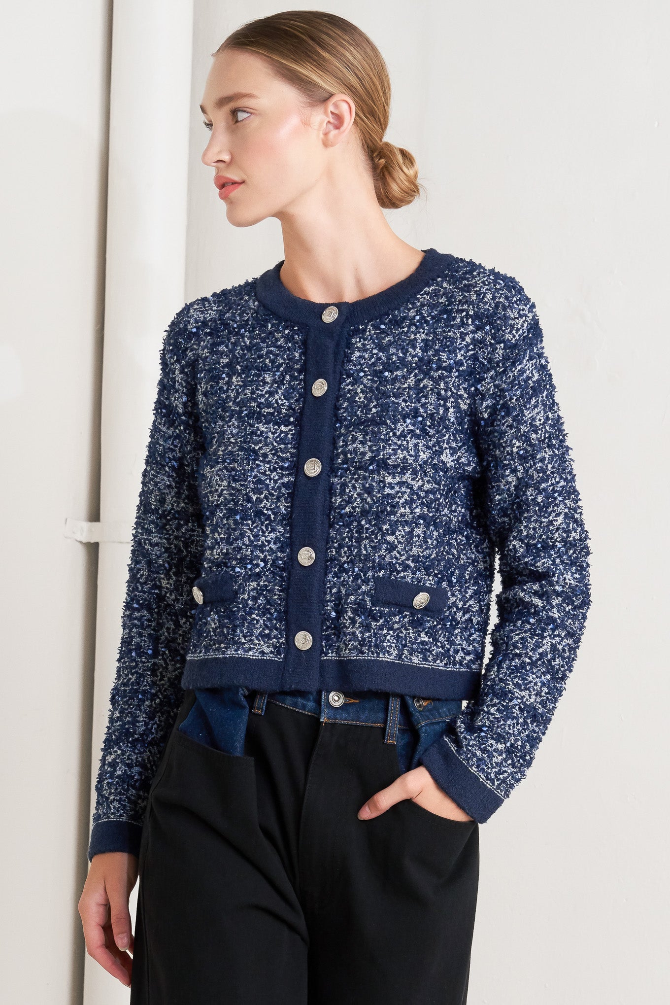 A sweater knit cardigan with front button closure