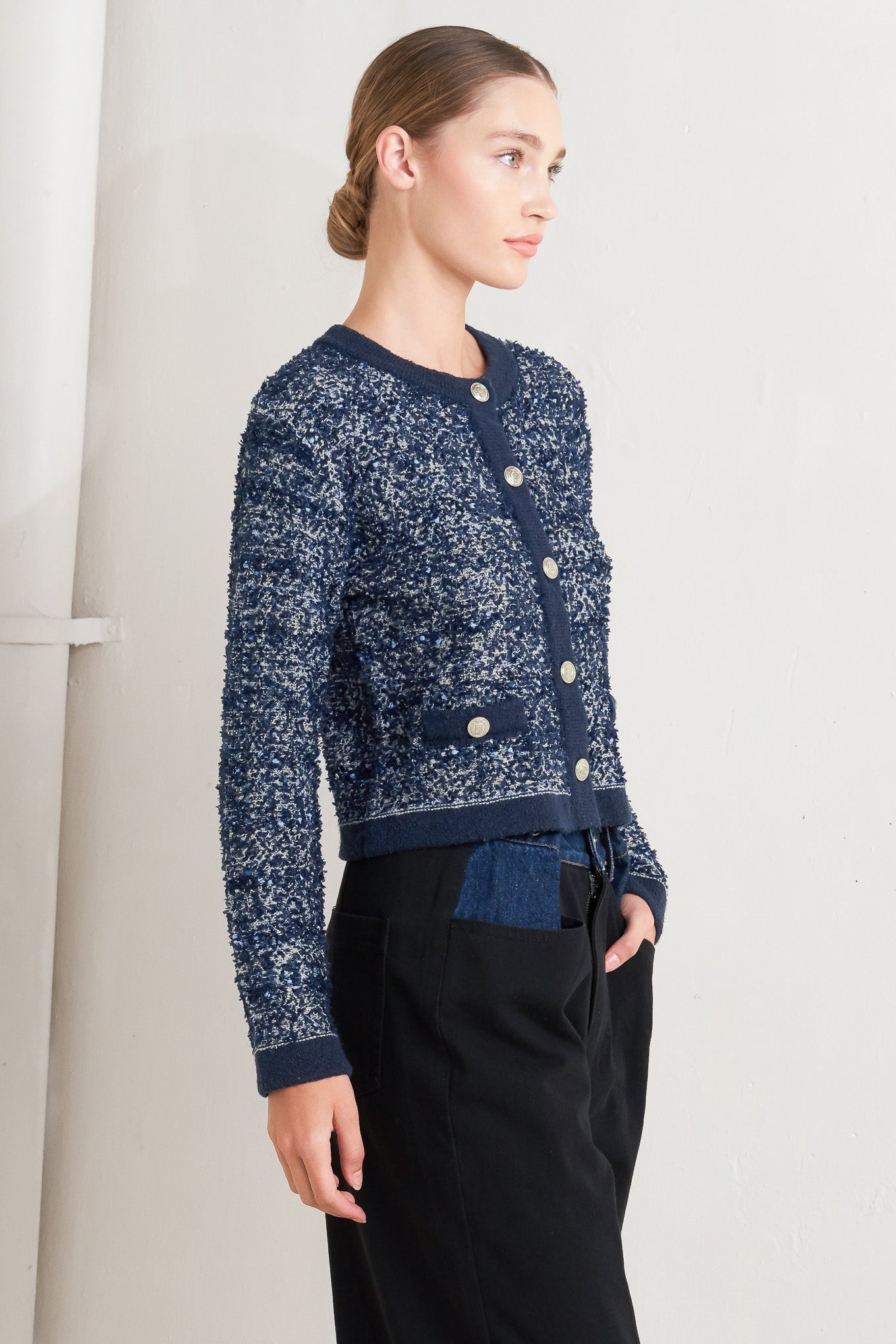 A sweater knit cardigan with front button closure