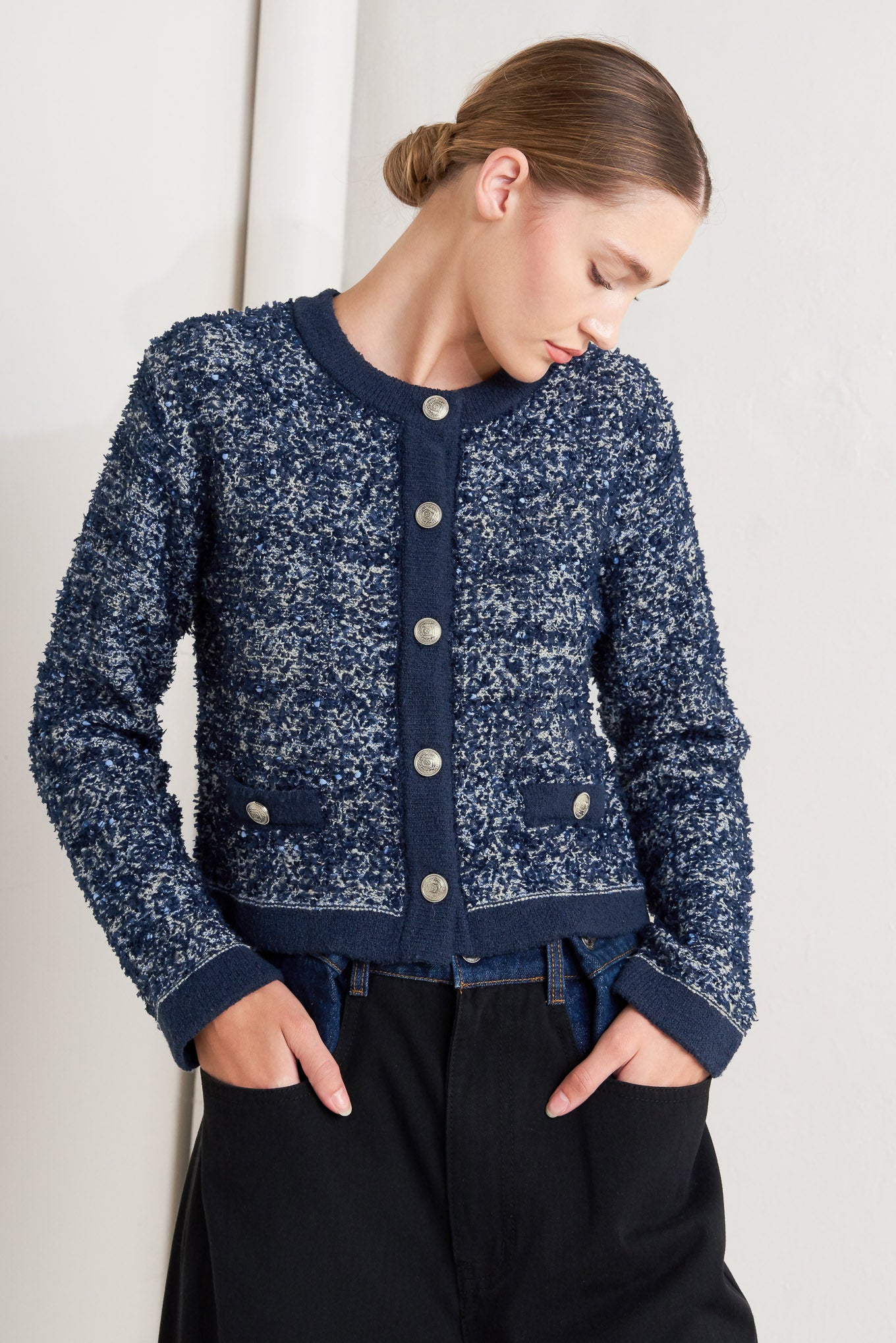 A sweater knit cardigan with front button closure