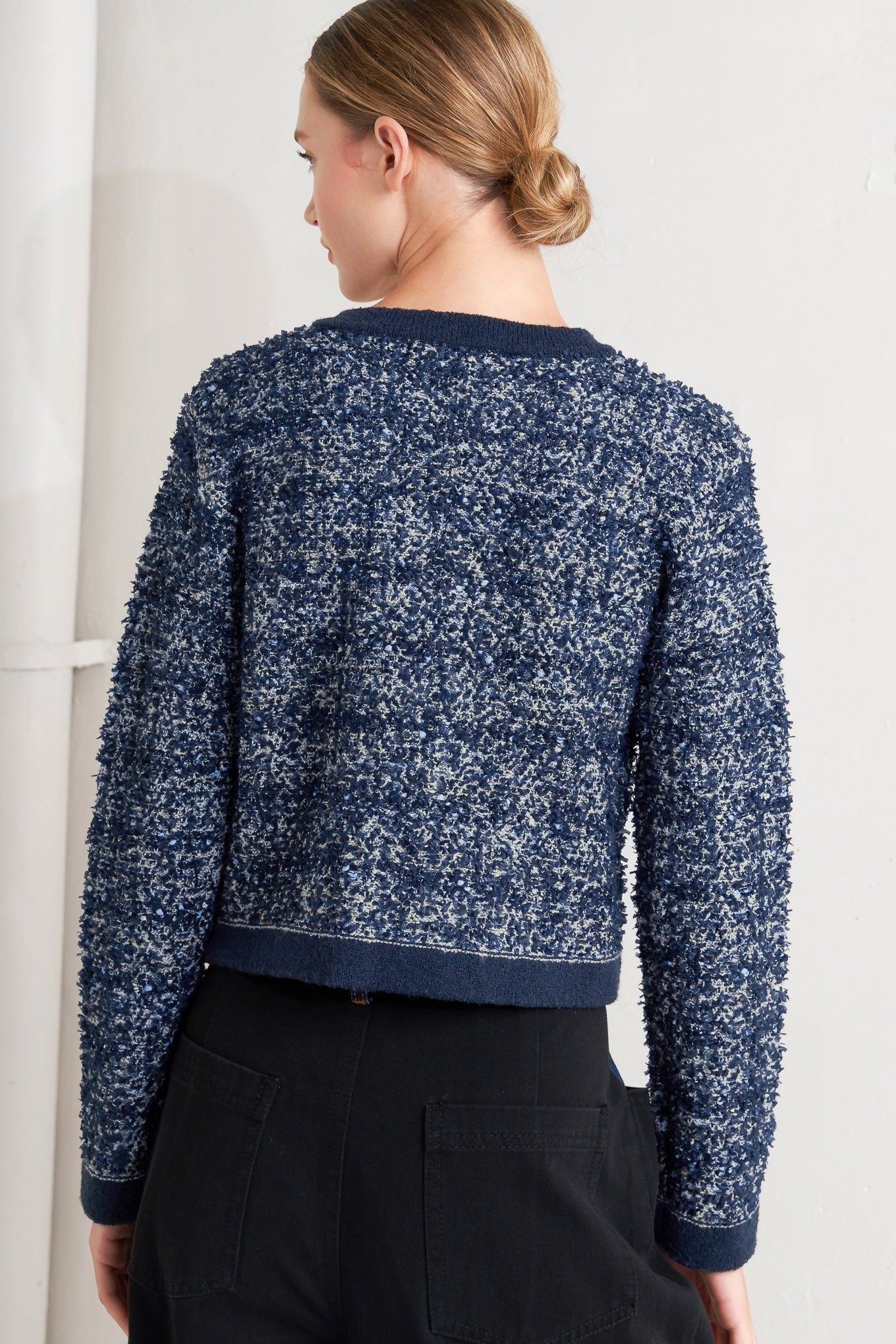 A sweater knit cardigan with front button closure