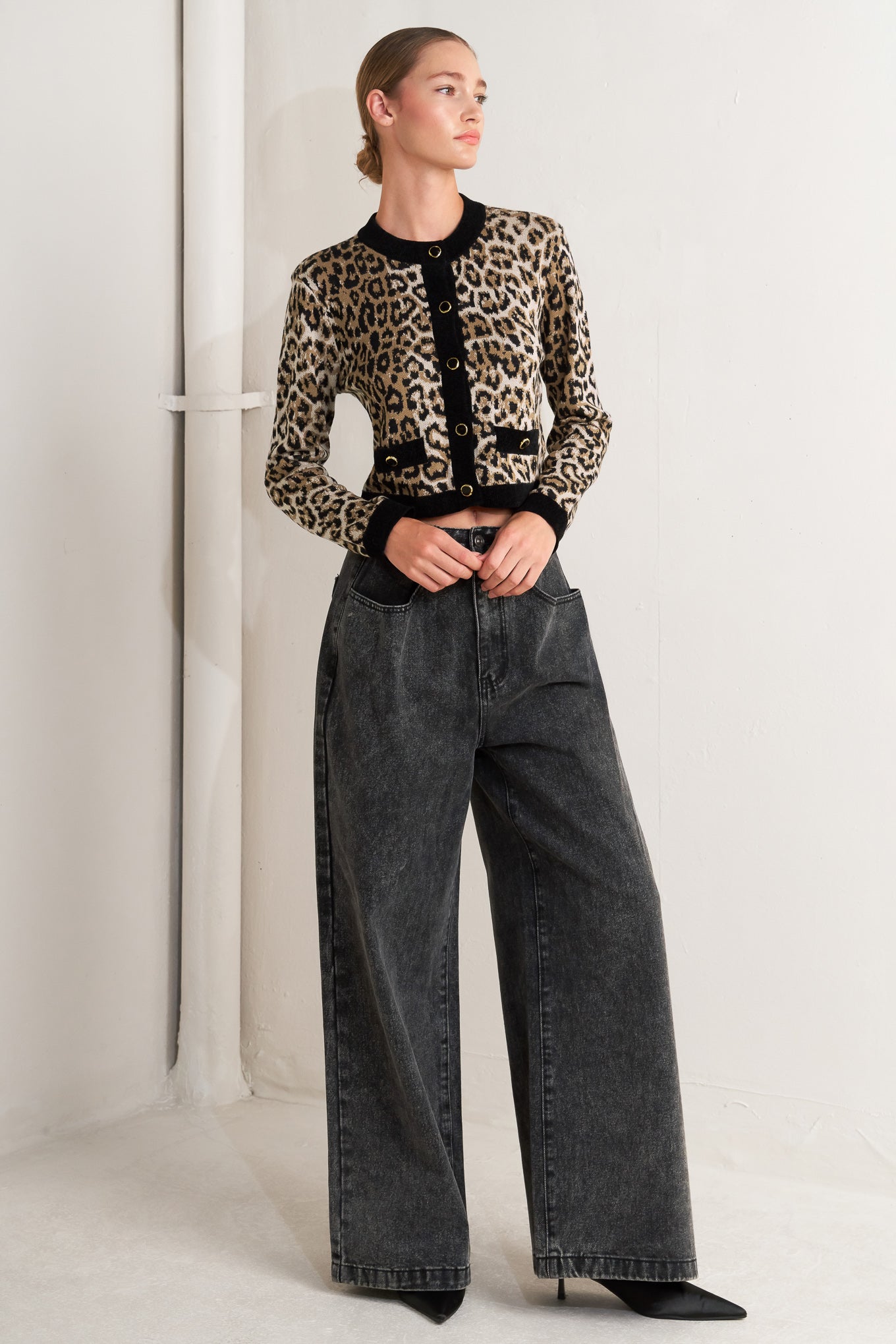 A sweater knit cardigan with round neckline, long sleeve and front button closure