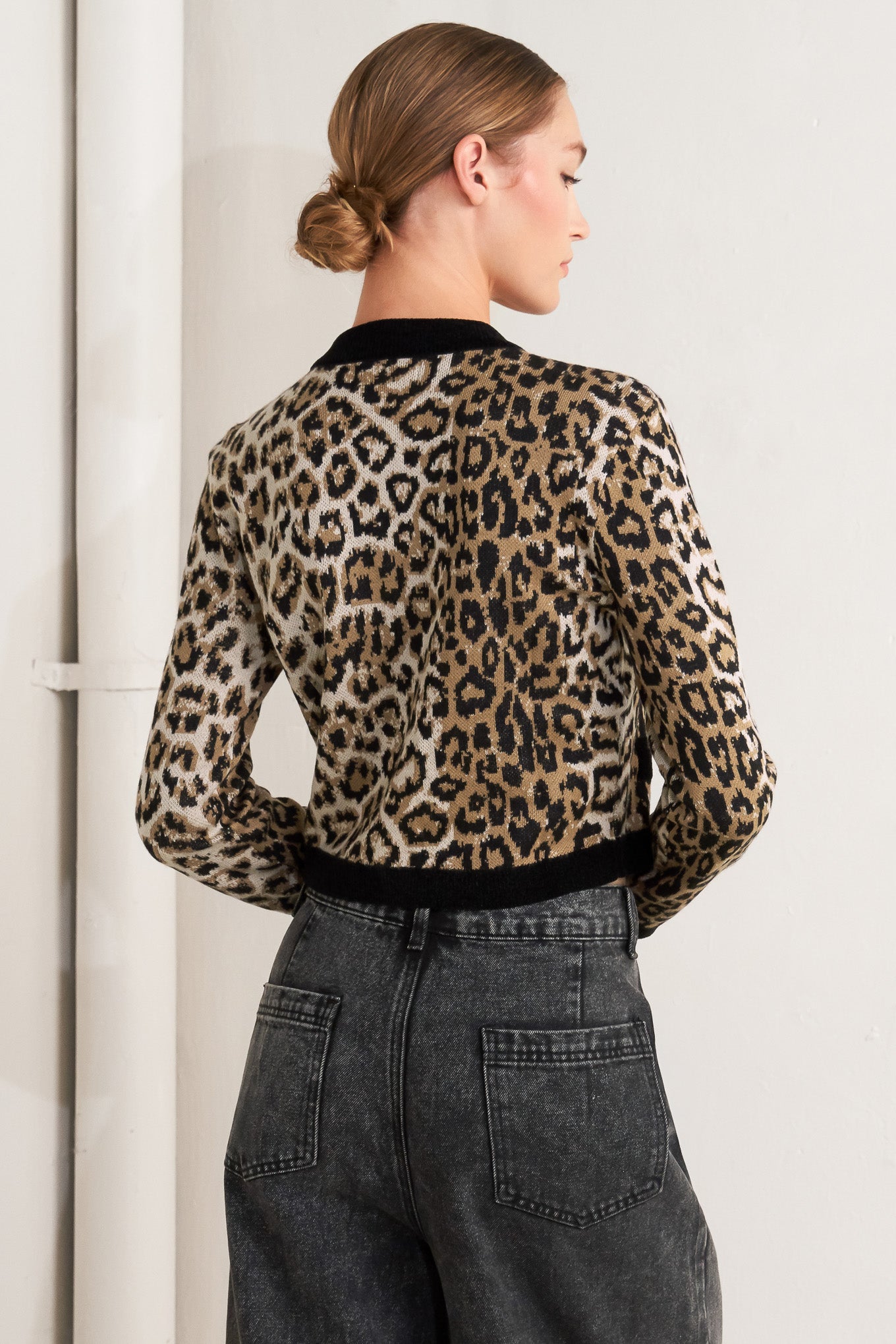 A sweater knit cardigan with round neckline, long sleeve and front button closure