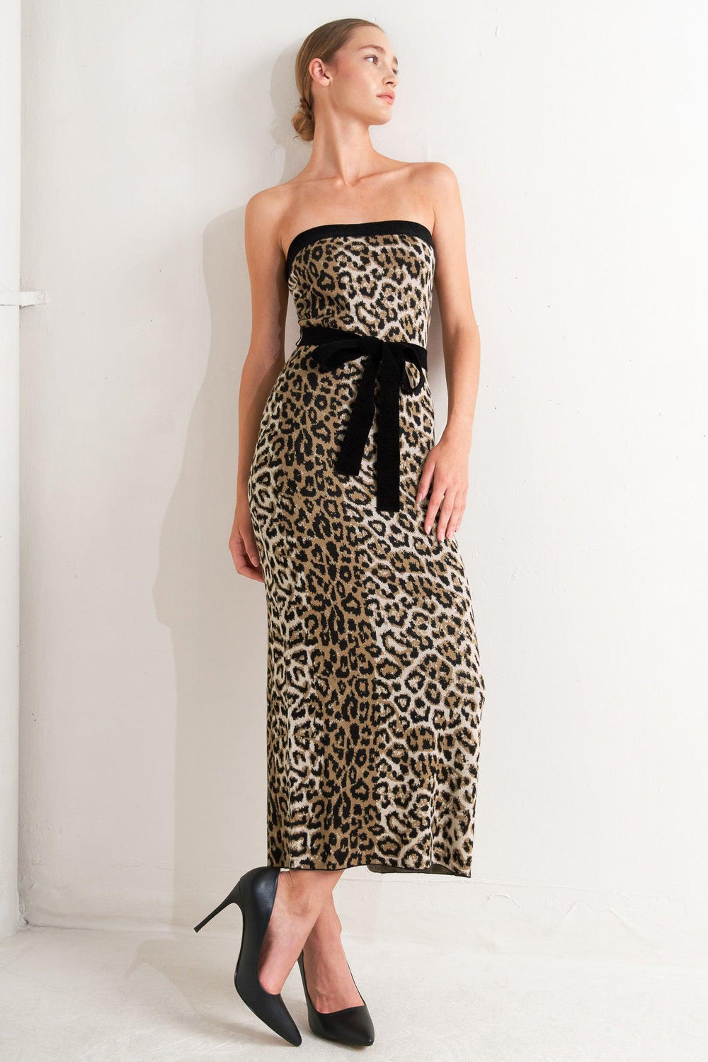 A sweater knit midi dress featuring strapless, contrasting belt and back slit