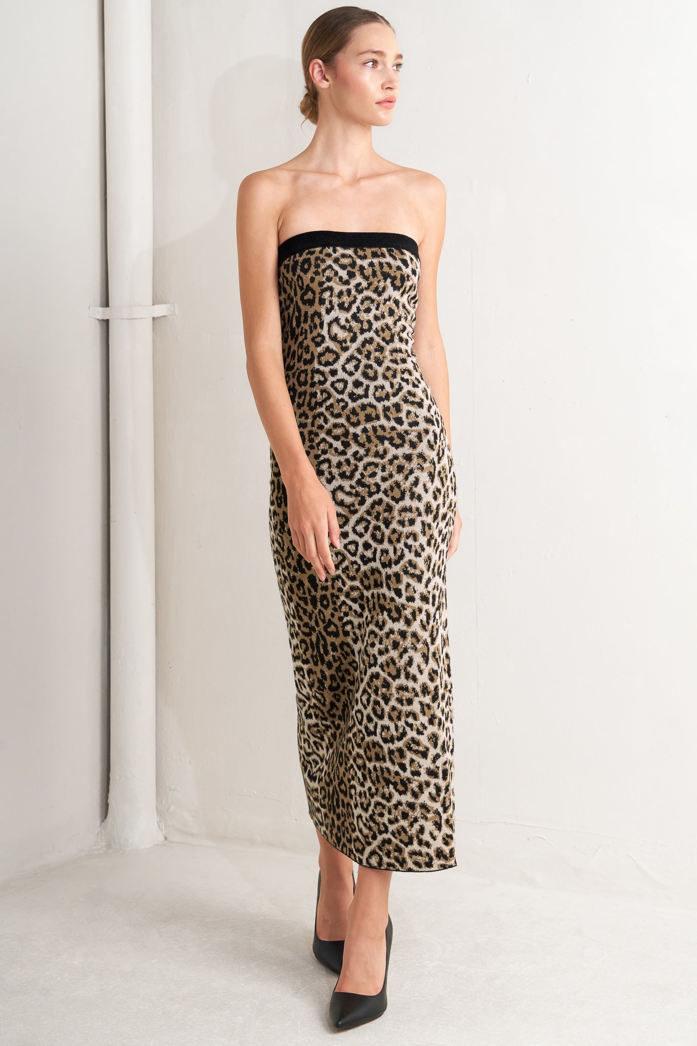 A sweater knit midi dress featuring strapless, contrasting belt and back slit