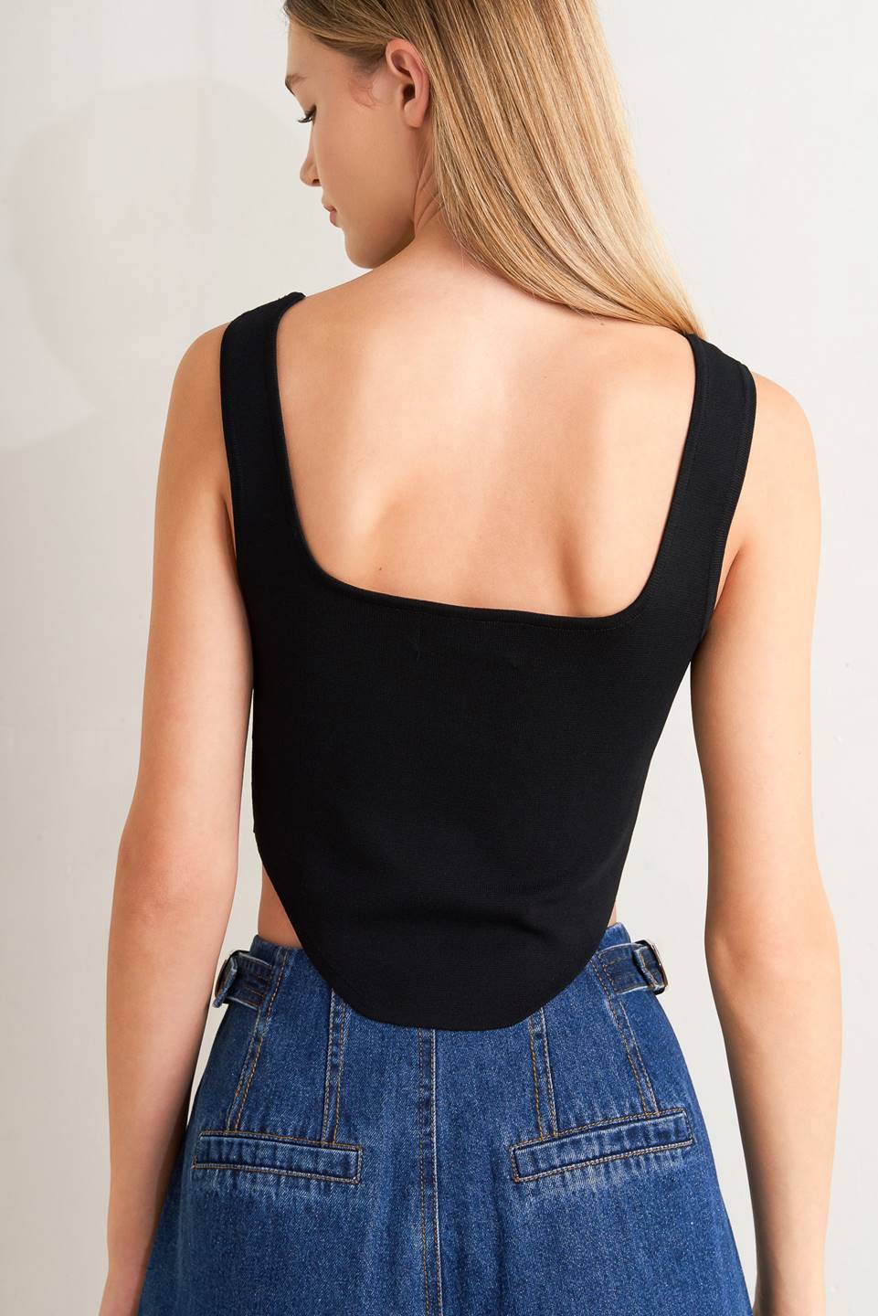 A sweater top featuring square neckline, sleeveless and button front detail