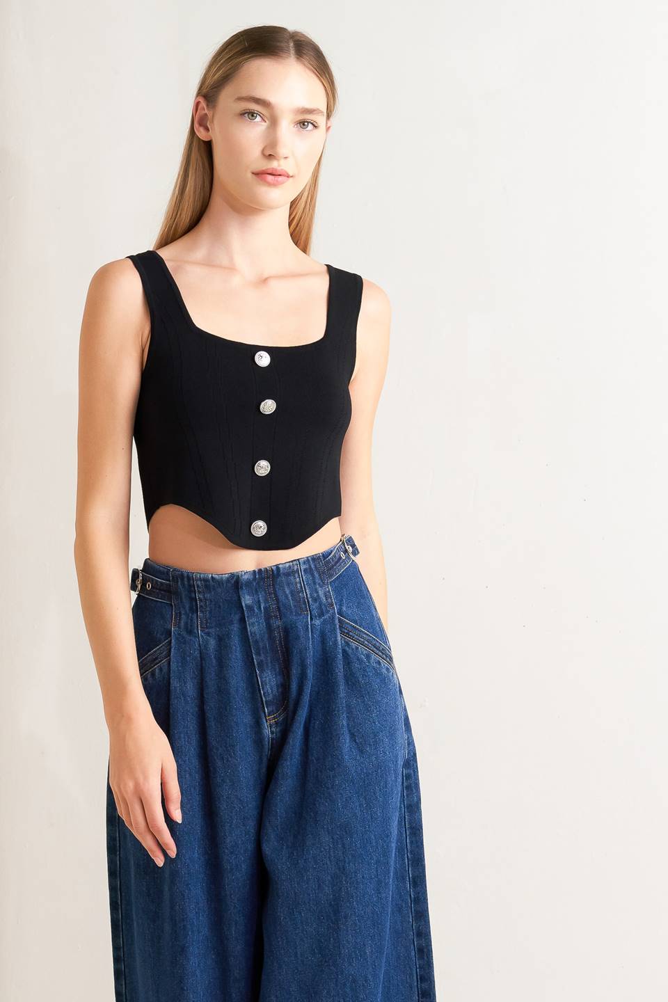 A sweater top featuring square neckline, sleeveless and button front detail