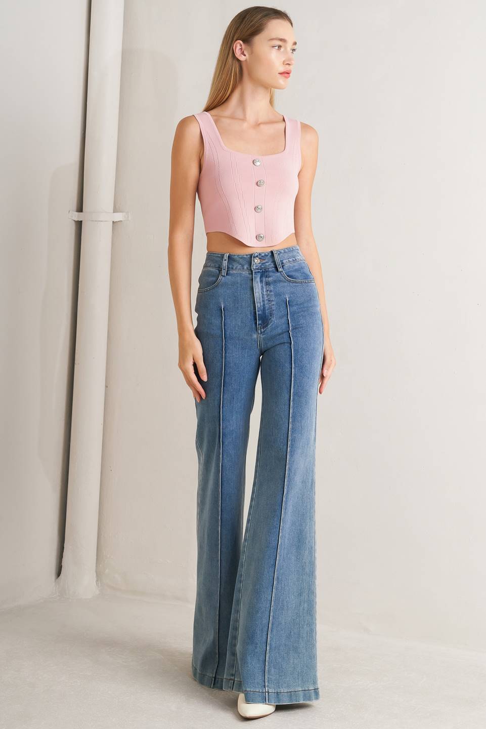 A sweater top featuring square neckline, sleeveless and button front detail