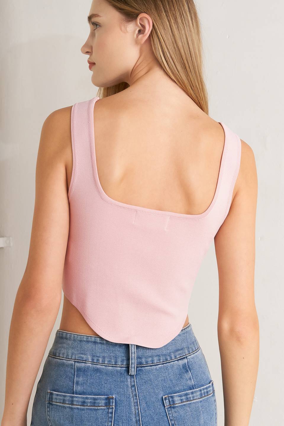A sweater top featuring square neckline, sleeveless and button front detail