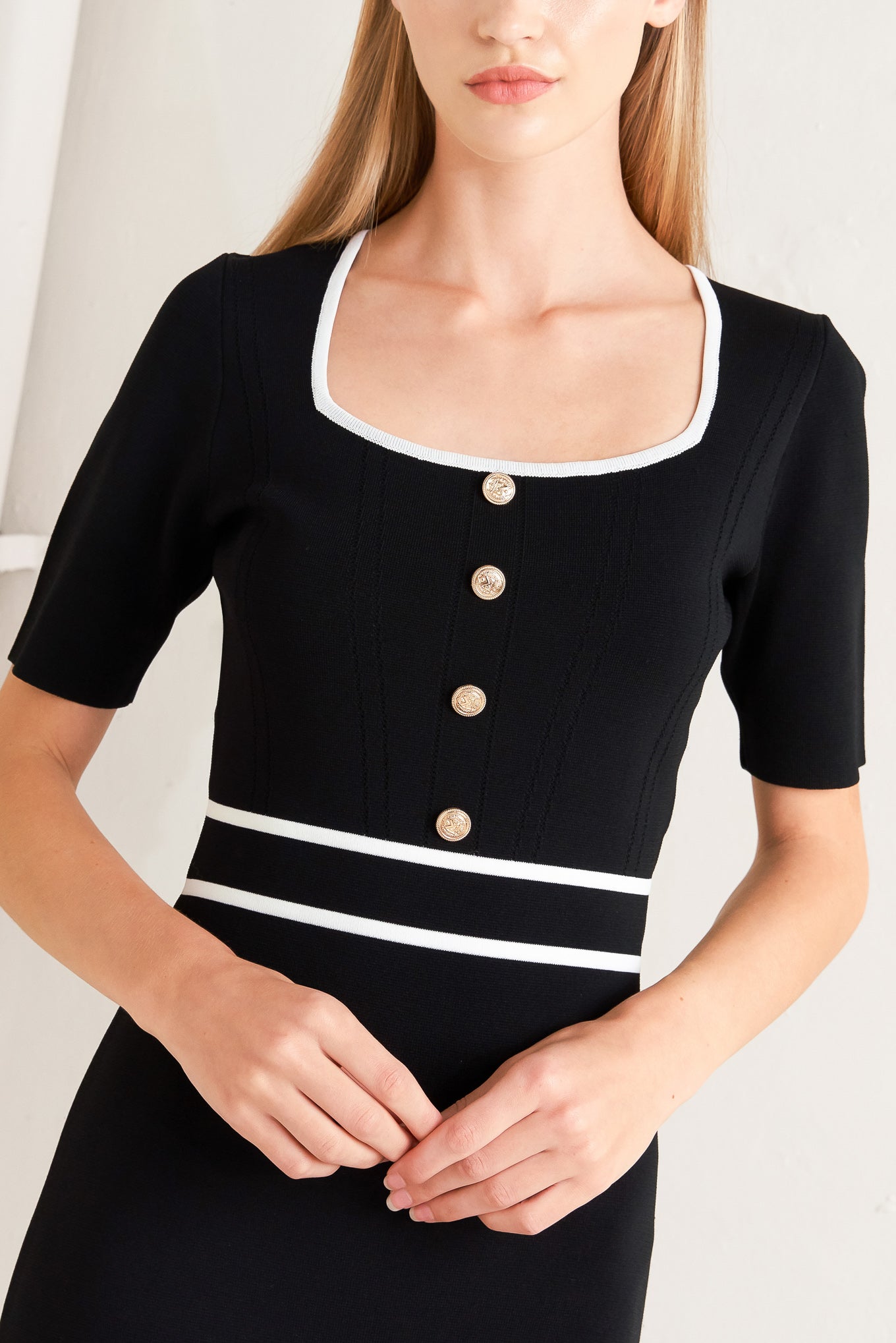 A sweater knit midi dress featuring square neckline, short sleeve and front button detail