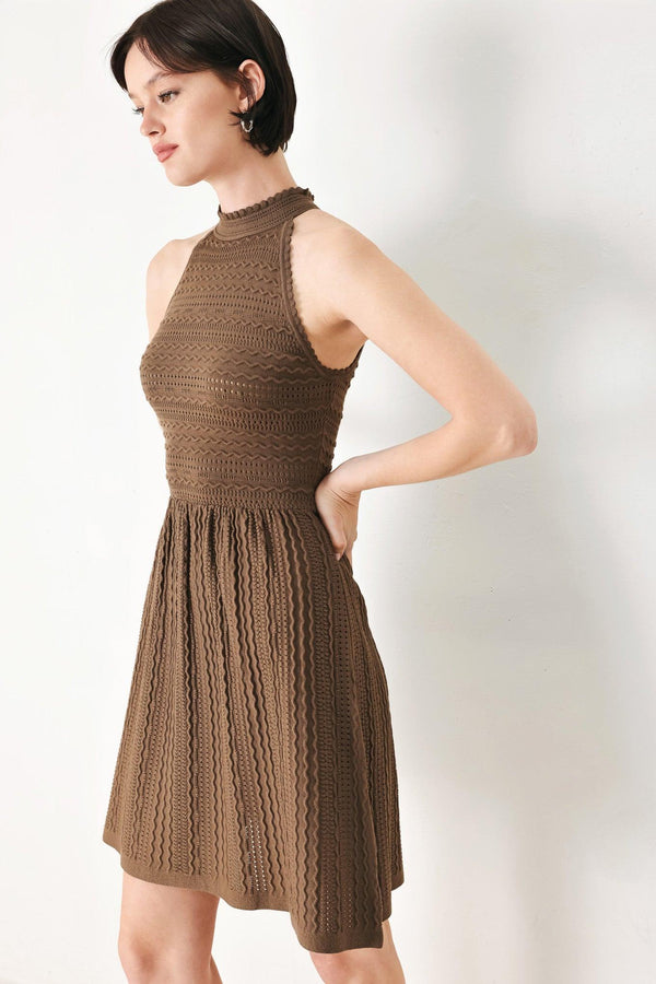 A sweater knit mini dress with halter neckline and back neck button closure