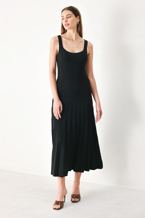 Woman wearing a black sleeveless sweater knit midi dress | Flying Tomato