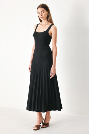 Woman wearing a black sleeveless sweater knit midi dress | Flying Tomato
