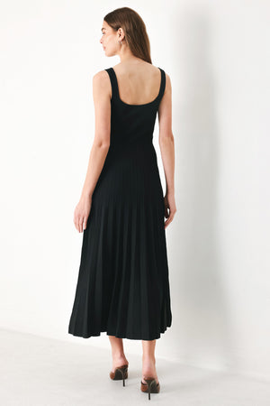 Woman wearing a black sleeveless sweater knit midi dress | Flying Tomato
