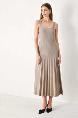 Woman wearing a beige pleated midi dress | Flying Tomato