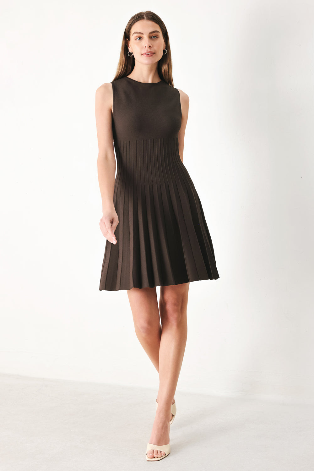 Woman wearing a brown sleeveless sweater knit mini dress with pleated skirt | FREEMARKET | Flying Tomato