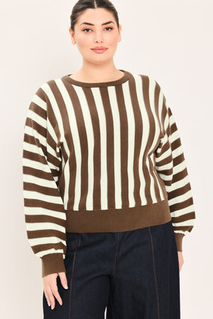 A woman wearing a brown and cream vertical striped knit sweater with long balloon sleeves and ribbed cuffs, paired with dark jeans | Plus Curve Flying Tomato