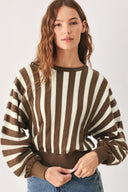 A woman wearing a brown and ivory striped long-sleeve knit top | FREEMARKET
