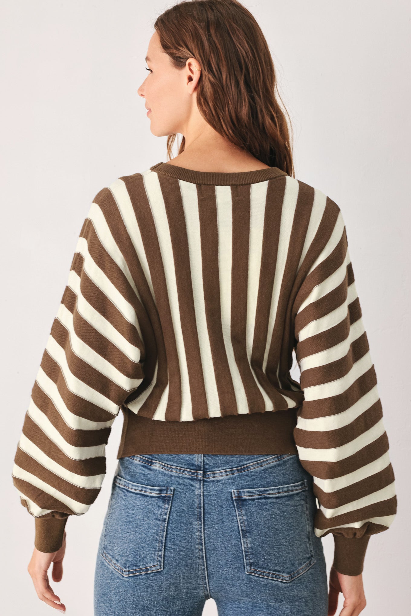 A woman wearing a brown and ivory striped long-sleeve knit top | FREEMARKET