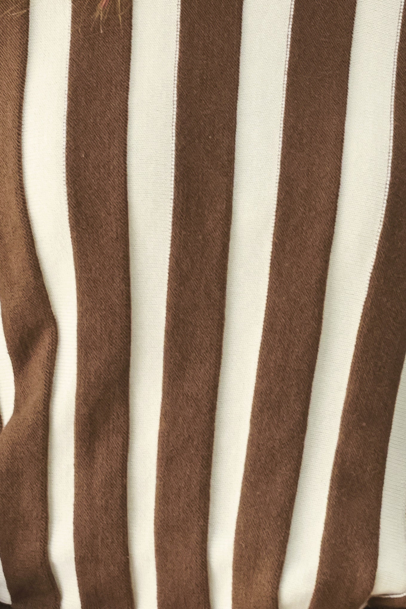 A woman wearing a brown and ivory striped long-sleeve knit top | FREEMARKET