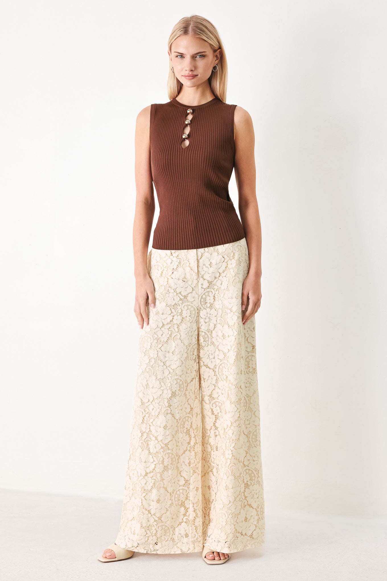 Woman wearing a brown ribbed sleeveless top with a cutout design | FREEMARKET