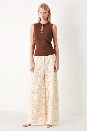 Woman wearing a brown ribbed sleeveless top with a cutout design | FREEMARKET